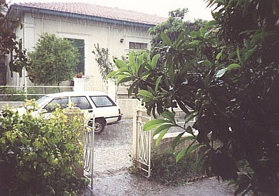 more rain; photo shows our front yard and car