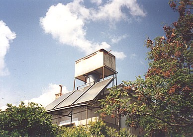 old, rusty water tank and solar panels