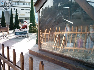 A display down-town, showing both Nativity figures and Santa Claus!