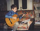 Tim playing his guitar, classical style