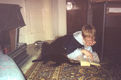 Daniel, with Cleo, reading by the kerosene heater