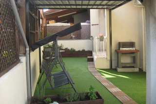 transformed side yard, with barbecue and artificial grass